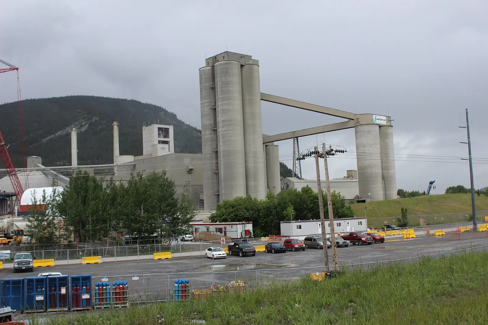 Cement plant with silos and preheater tower in daylight